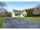 Lovely single-level home featuring a green door, matching shutters and ample parking on a paved driveway at 158 Angel Oaks Dr, Statesville, NC 28677