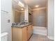 Bathroom featuring a double sink vanity with granite countertops and a tub-shower combo at 210 N Church St # 3606, Charlotte, NC 28202