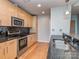Modern kitchen with wood cabinets, stainless steel appliances, and a granite countertop with a sink at 210 N Church St # 3606, Charlotte, NC 28202
