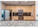 Well-lit kitchen showcasing granite countertops, stainless steel appliances, and sleek black backsplash at 210 N Church St # 3606, Charlotte, NC 28202