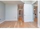 Open living room showcasing hardwood floors leading to the bathroom with a shower and tub at 210 N Church St # 3606, Charlotte, NC 28202