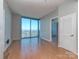 Bright, empty living room with hardwood floors and large windows offering panoramic city views at 210 N Church St # 3606, Charlotte, NC 28202