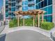 Outdoor lounge area featuring a pergola with comfortable seating, surrounded by lush landscaping and greenery at 210 N Church St # 3606, Charlotte, NC 28202