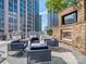 Outdoor patio with comfortable seating, a fireplace and a grill, perfect for outdoor dining and relaxation at 210 N Church St # 3606, Charlotte, NC 28202