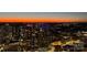 An impressive aerial view of the city skyline with many illuminated buildings during twilight at 210 N Church St # 3606, Charlotte, NC 28202