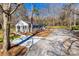 Aerial view of a charming single-story home with a spacious driveway and beautifully landscaped surroundings at 2478 Stribling Cir, Lancaster, SC 29720