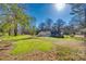 Lush, expansive backyard view featuring mature trees, offering ample space for outdoor activities at 2478 Stribling Cir, Lancaster, SC 29720