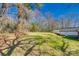Spacious backyard with mature trees, green grass, partial home view, ideal for outdoor activities at 2478 Stribling Cir, Lancaster, SC 29720