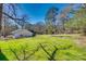 Spacious backyard featuring green grass, scattered trees, offering a serene outdoor retreat at 2478 Stribling Cir, Lancaster, SC 29720