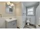 Bathroom featuring grey vanity, wainscotting, sink, tile flooring, and window at 2478 Stribling Cir, Lancaster, SC 29720