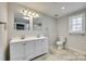 Bathroom featuring double sinks, vanity, tile flooring, and window at 2478 Stribling Cir, Lancaster, SC 29720