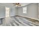 Empty bedroom featuring hardwood floors, ceiling fan, ensuite bathroom, and natural lighting at 2478 Stribling Cir, Lancaster, SC 29720
