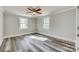 Bedroom featuring hardwood floors, two bright windows, ceiling fan, and gray walls at 2478 Stribling Cir, Lancaster, SC 29720