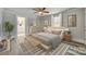 Stylish bedroom featuring hardwood floors, ceiling fan, ensuite bathroom, and decor at 2478 Stribling Cir, Lancaster, SC 29720