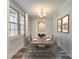 Formally staged dining room featuring a wood table, seating for six, a chandelier, and neutral decor at 2478 Stribling Cir, Lancaster, SC 29720