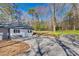 View of the driveway and side of the home with white siding, complementing the beautifully landscaped backyard at 2478 Stribling Cir, Lancaster, SC 29720