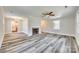 Bright, open living room with hardwood floors, a cozy fireplace, large windows, and a view into the updated kitchen at 2478 Stribling Cir, Lancaster, SC 29720