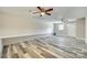 Open-concept living room with hardwood floors, neutral walls, updated lighting, and a brick foundation border at 2478 Stribling Cir, Lancaster, SC 29720