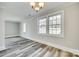 Open-concept living room featuring large windows, grey walls, updated lighting, and new hardwood floors at 2478 Stribling Cir, Lancaster, SC 29720