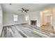Spacious living room with fireplace, hardwood floors, fresh paint, ample natural light, and a ceiling fan at 2478 Stribling Cir, Lancaster, SC 29720