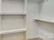 A walk-in closet with built-in white shelving, perfect for organization and storage solutions at 2478 Stribling Cir, Lancaster, SC 29720