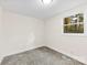 Bright bedroom features neutral paint, plush carpeting, and natural light from the large window at 2706 Booker St, Gastonia, NC 28054