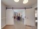 Open dining room featuring stylish barn doors, hardwood floors and room for a large table at 306 Stevens St, Monroe, NC 28112