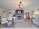 Inviting living room featuring a brick fireplace, custom built-ins, wood floors, and modern decor at 306 Stevens St, Monroe, NC 28112