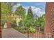 View from the deck of a verdant fenced backyard at 309 Settlers Ln, Charlotte, NC 28202