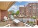 Condo balcony featuring a table and chairs, with views of a vintage red brick building at 309 Settlers Ln, Charlotte, NC 28202