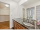 Bathroom featuring an extended vanity with granite countertop and large mirror at 309 Settlers Ln, Charlotte, NC 28202