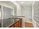 Bathroom with double sink vanity, granite countertop, glass block window and glass enclosed shower at 309 Settlers Ln, Charlotte, NC 28202