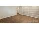 Bedroom featuring built-in bookshelves, neutral walls, and tile flooring at 309 Settlers Ln, Charlotte, NC 28202