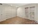 Bedroom with built-in bookshelves and a door leading to an outdoor area at 309 Settlers Ln, Charlotte, NC 28202