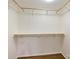 Walk-in closet with custom shelving and wooden rods for optimal organization at 309 Settlers Ln, Charlotte, NC 28202
