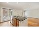 The kitchen is open to the living room, featuring dark countertops and hardwood floors at 309 Settlers Ln, Charlotte, NC 28202