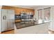 This kitchen features stainless steel appliances, dark countertops, and wood cabinetry at 309 Settlers Ln, Charlotte, NC 28202
