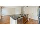 The kitchen has dark countertops, hardwood floors, and stainless steel dishwasher at 309 Settlers Ln, Charlotte, NC 28202