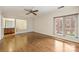 Spacious living room featuring hardwood floors, large windows, and a ceiling fan at 309 Settlers Ln, Charlotte, NC 28202