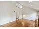 Bright living room with hardwood floors, fireplace, high ceilings, and a second-floor view adding architectural interest at 309 Settlers Ln, Charlotte, NC 28202