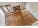 Aerial view of living room with hardwood floors, brick fireplace, large windows, and adjacent French doors at 309 Settlers Ln, Charlotte, NC 28202