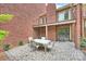 Charming brick patio with outdoor seating, adjacent to the home's entrance and balcony at 309 Settlers Ln, Charlotte, NC 28202
