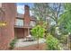 A brick patio offers an outside area to enjoy, nestled within a landscaped setting at 309 Settlers Ln, Charlotte, NC 28202