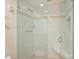 Glass-enclosed shower with tile surround, built-in bench, and modern fixtures at 309 Settlers Ln, Charlotte, NC 28202