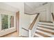 The stairway features hardwood floors, a window, and a brick wall at 309 Settlers Ln, Charlotte, NC 28202