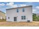 Exterior view of the home with a concrete patio and a grassy backyard at 4010 Richard Andrew Dr, Matthews, NC 28105