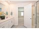 Bathroom with dual sinks, a large mirror, and a glass-enclosed shower at 4010 Richard Andrew Dr, Matthews, NC 28105