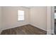 The bedroom shows a window for natural light and hardwood floors at 4010 Richard Andrew Dr, Matthews, NC 28105