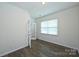 The bedroom shows a window for natural light and hardwood floors at 4010 Richard Andrew Dr, Matthews, NC 28105