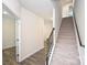 Bright foyer features hardwood flooring, white walls, and a carpeted staircase to the upper level at 4010 Richard Andrew Dr, Matthews, NC 28105